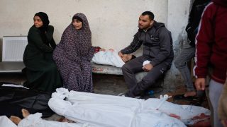 SENSITIVE MATERIAL. THIS IMAGE MAY OFFEND OR DISTURB Mourners react next to the body of a child and other bodies of Palestinians killed in Israeli strikes, amid the ongoing conflict between Israel and the Palestinian Islamist group Hamas, at Abu Yousef Al-Najjar hospital, in Rafah, in the southern Gaza Strip, February 12, 2024. REUTERS/Mohammed Salem